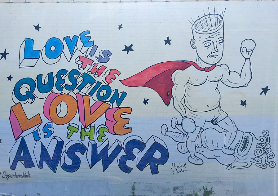 Daniel Johnston mural in Austin, Texas. Vile Corrupt is knocked out by Punchin' Joe. Titled: Love is the Question, Love is the Answer.